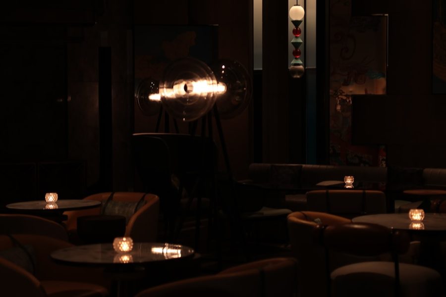 Intimate candle-lit lounge interior prepared for a private casino-themed party